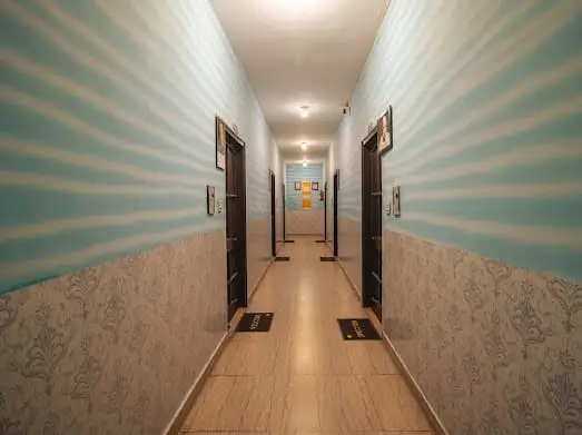 Guest room corridor with polished floor at Rishikesh Yog Kendra
