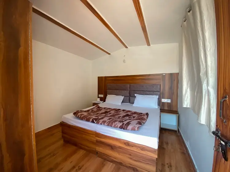 Deluxe room with wooden ceiling at Rishikesh Yog Kendra