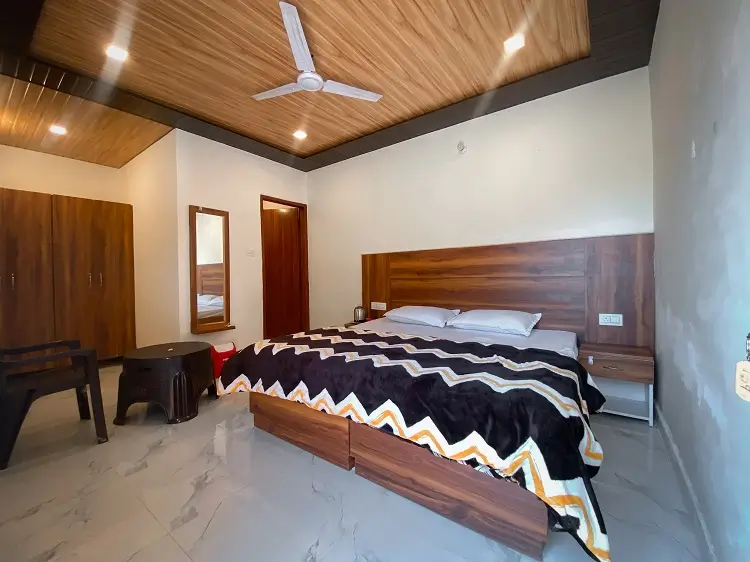 Large room with wardrobe and seating at Rishikesh Yog Kendra