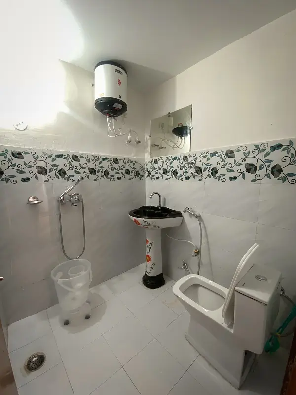 Attached washroom with hot water at Rishikesh Yog Kendra